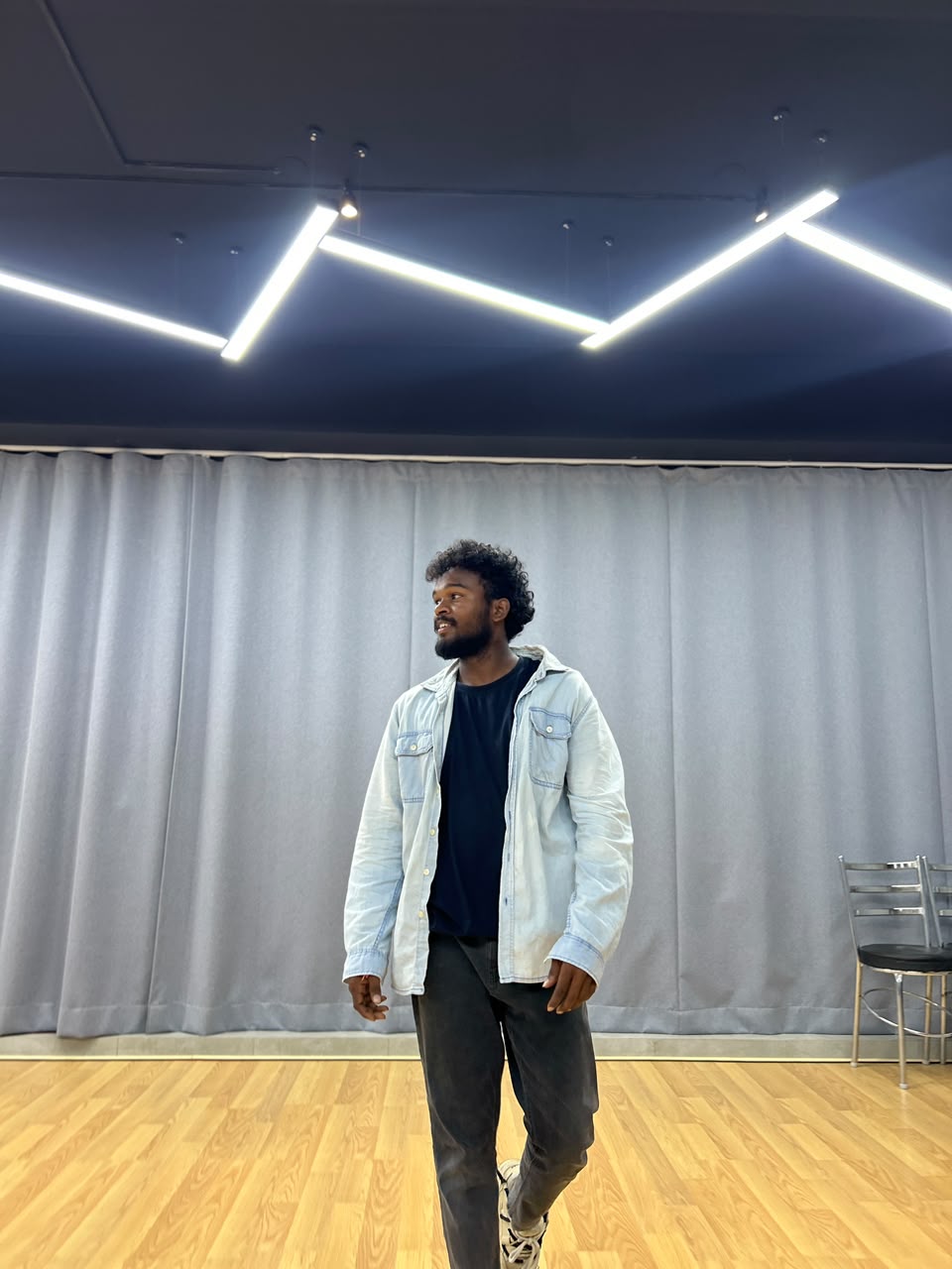 Dharshan, dance instructor, standing in the Nataraj studio
